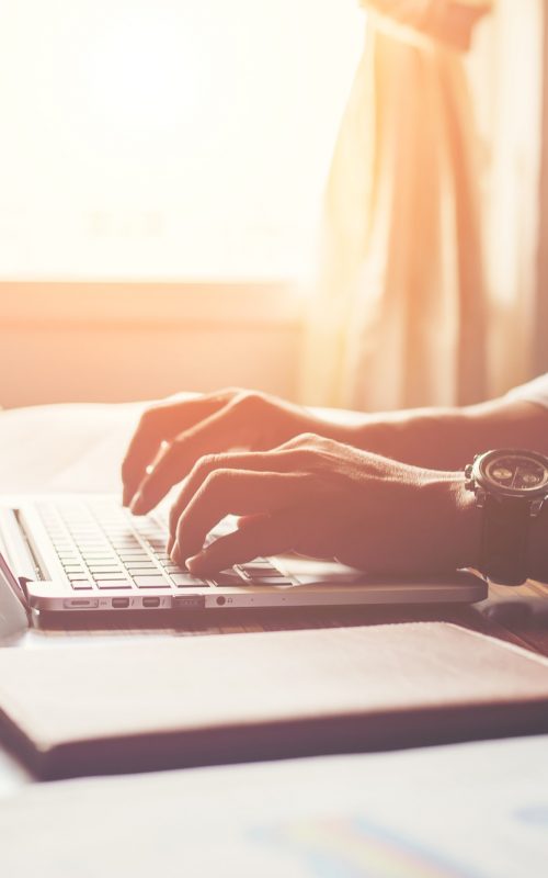 Close-up of male hands using laptop in home. Close-up of male hands using laptop in home.
